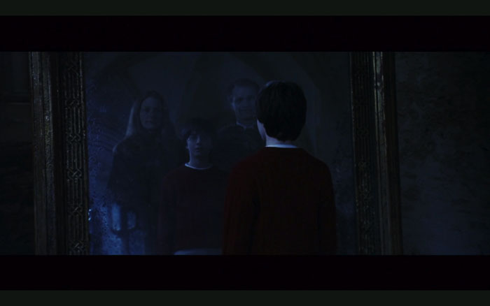 映画「ハリー・ポッターと賢者の石』より みぞの鏡が出るシーン。ハリー・ポッターには両親と並ぶ姿が見える。